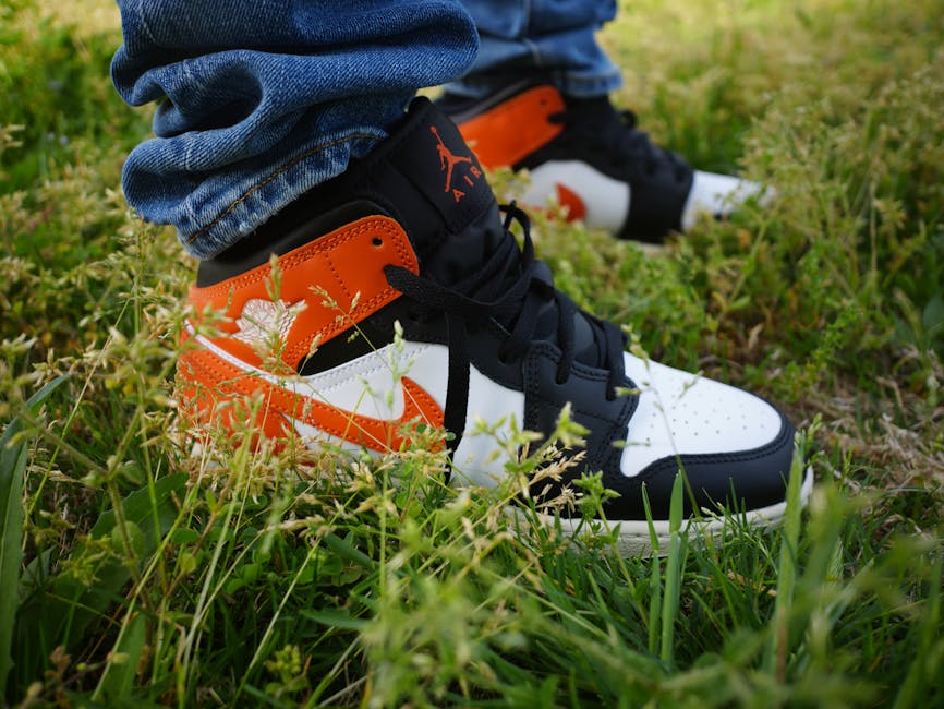 Close-up of trendy sneakers on green grass, exuding a vibrant urban style in Memphis.